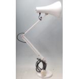 A vintage 20th Century Herbert Terry Industrial anglepoise desk lamp in a white colourway, raised on