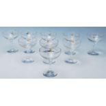 A set of nine vintage retro Babycham advertising glasses having gilt rims with hexagonal stems and