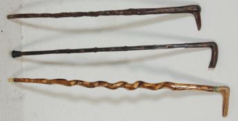 A collection of three late 20th Century wooden walking sticks / canes to include a bone handled