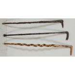 A collection of three late 20th Century wooden walking sticks / canes to include a bone handled