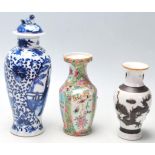 A group of three Chinese porcelain vases to include a blue and white hand painted lidded vase having