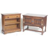 A Jaycee / Old Charm manner bookcase raised on plinth base with central shelves together with a good