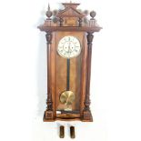 An early 20th century mahogany cased Vienna regulator wall clock having a pediment top flanked by