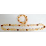 A vintage faux amber necklace and matching bracelet having cream plastic teardrop shaped beads and