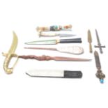 A collection of 19th Century and later weapons to include a commando knife, a Tibetan knife with