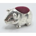 A stamped 925 sterling silver pincushion in the form of a guinea pig with velvet cushion to the