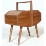 A vintage 20th century circa 1970's stylish teak wood sewing box with hinged lids, handle above