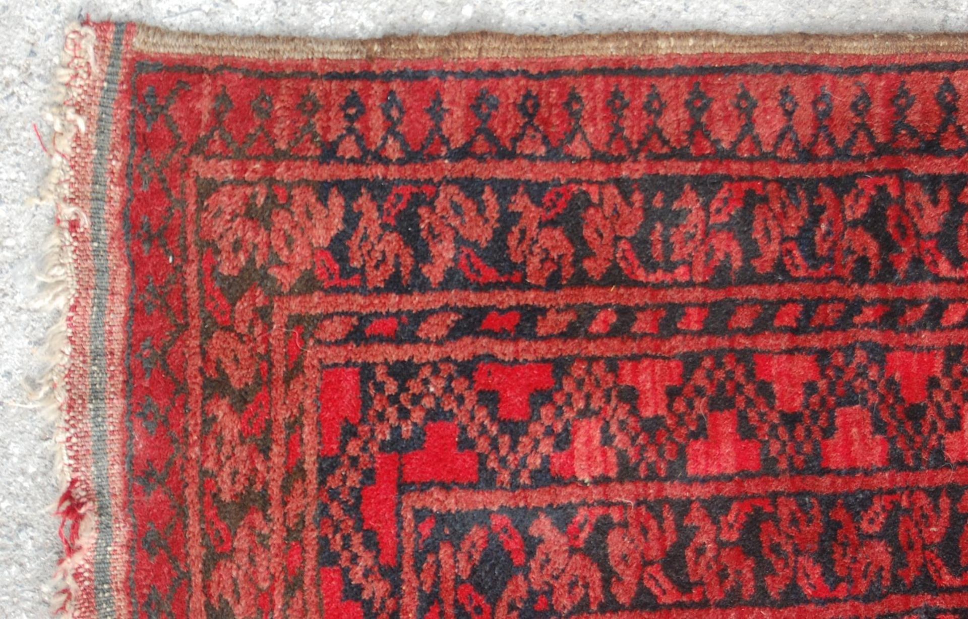 A pair of Islamic / Persian carpet rugs comprising of a red and black carpet having three - Image 4 of 9