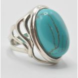 A large silver 925 art deco style dress ring set with a large central turquoise stone. Measures: