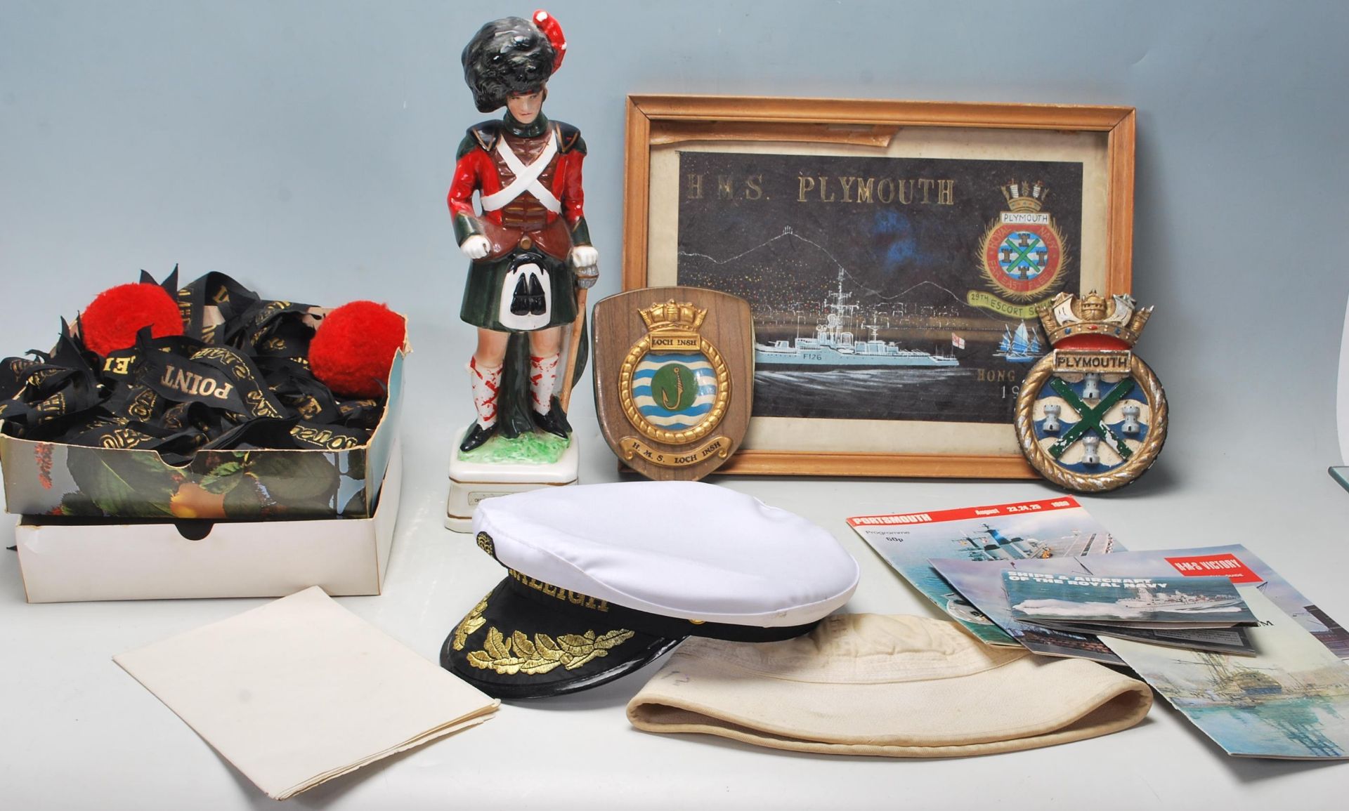 A group of Royal Navy / Naval related items to include a framed HMS plymouth painting on black, a