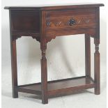A early 20th Century Edwardian oak hall table of angular form having a single carved drawer with a