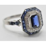 A platinum sapphire and diamond cocktail ring. The ring set with a central octagon cut sapphire with