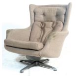A retro mid century / 1970's period swivel easy chair - armchair. The chair being raised on a four
