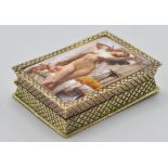 A gold plated silver ladies pill box having an enamel set erotic maiden to the top with chase