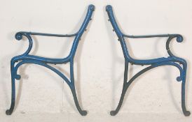 A pair of 20th Century antique  cast iron scroll work garden bench ends painted in blue.