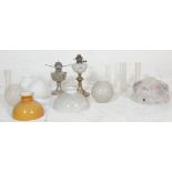 A good collection of 20th century antique oil lamp parts to include milk glass spherical shades, oil