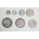 A collection of 7 antique British coins all dating from 1887 to include a Crown, Double Florin, Half