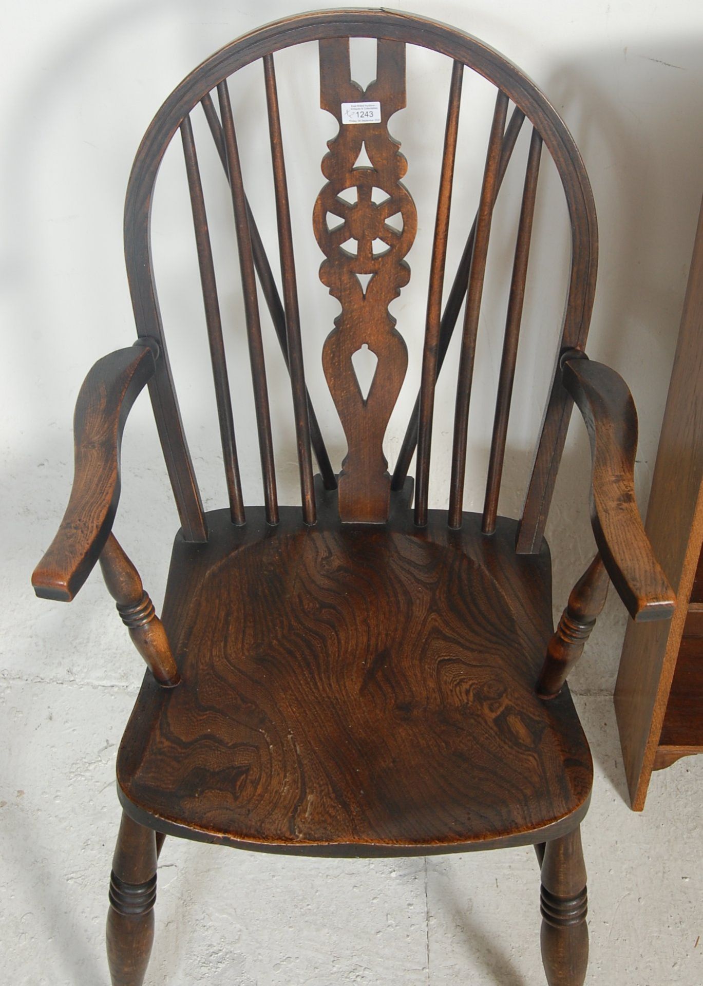 A Victorian 19th century beech and elm wood Wheel back Windsor armchair. The chair being raised on - Bild 3 aus 5