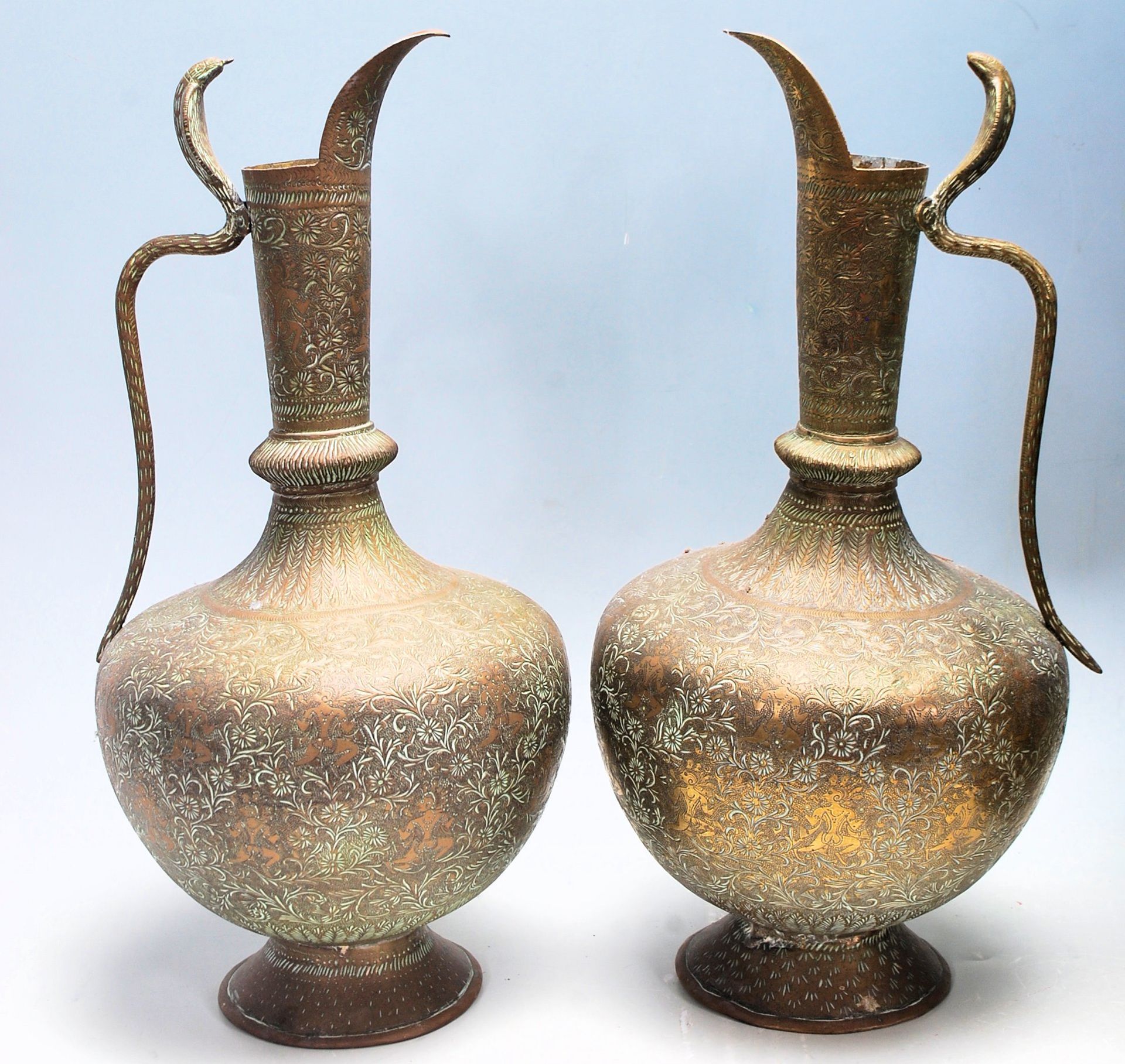A pair of Indian brass ewer jugs having bulbous tapering bodies raised on footed bases with cobra - Bild 2 aus 7