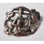 A late 19th Century Victorian  Art Nouveau brooch cast with a seated nude female figure surrounded