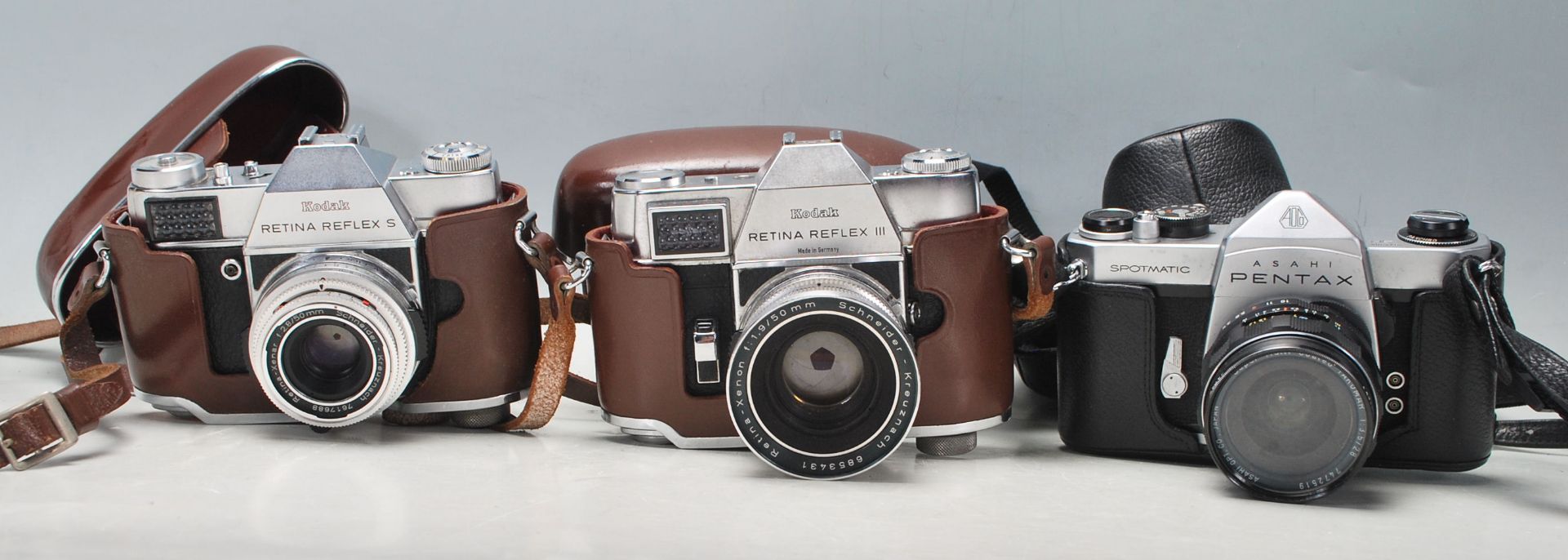 A group of vintage 20th century 35mm cameras to include a Kodak Retina Reflex III with aluminium