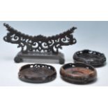 A group of four 20th Century carved Chinese hardwood stands to include a large plate holder with