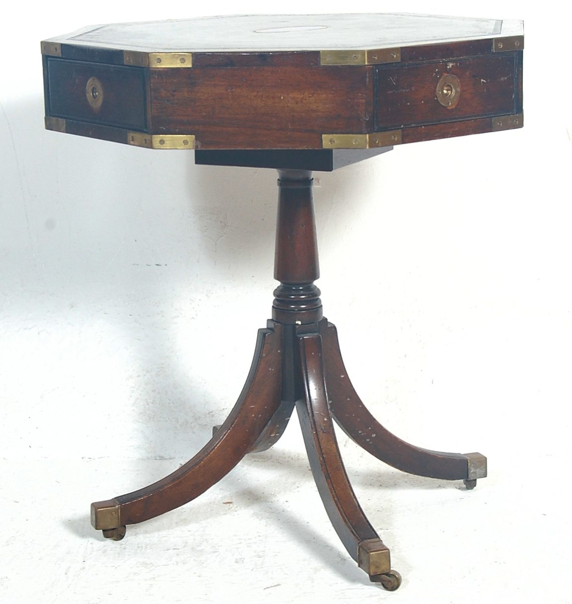 A regency revival mahogany campaign hexagonal drum table / occasional table / rent table having a