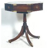 A regency revival mahogany campaign hexagonal drum table / occasional table / rent table having a