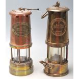 A pair of Victorian 19th century brass and copper miners lamps. Each of cylindrical form with