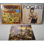 A collection of three vintage vinyl records by The Pogues to include Peace and Love, Rum Sodomy