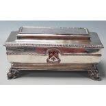 A silver hallmarked 1930's presentational box of sarcophagus form having moulded borders with an