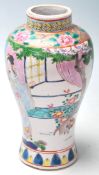 A 20th Century Chinese famille rose canton vase of wasted form being hand painted with two female