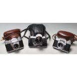 A group of three vintage 20th century 35mm photograph cameras to include a Nikkormat 35mm camera