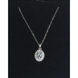 An 18ct white gold, aquamarine and diamond set necklace pendant set to a gold back chai. Stamped 750