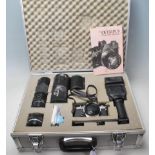 A vintage 20th century OLYMPUS OM- 1 N 35mm camera in a aluminium carry case along with flash,