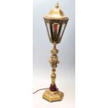 An early 20th Century brass desk lamp in the style of a Victorian street lamp having a fire shaped