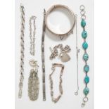 A group of silver bracelets to include a turquoise cabochon bracelet, a hanged bangle with