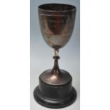 A silver hallmarked trophy of typical form raised on an ebonised socle plinth. The trophy being