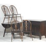 A contemporary 20th century Ercol Furniture beech and elm wood dining room suite comprising a drop