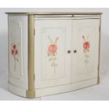 A  mid century shabby chic painted lozenge shaped French commode cupboard. The cupboard with twin