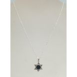 A silver 925 hallmarked pendant necklace in the form of Star of David set with marcasite's.