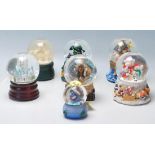 A collection of seven original vintage collectable glass snow globes to include: two angels