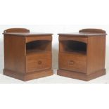 A pair of 20th century Ercol style elm  bedside cabinets by Jentique. Each being raised on plinth