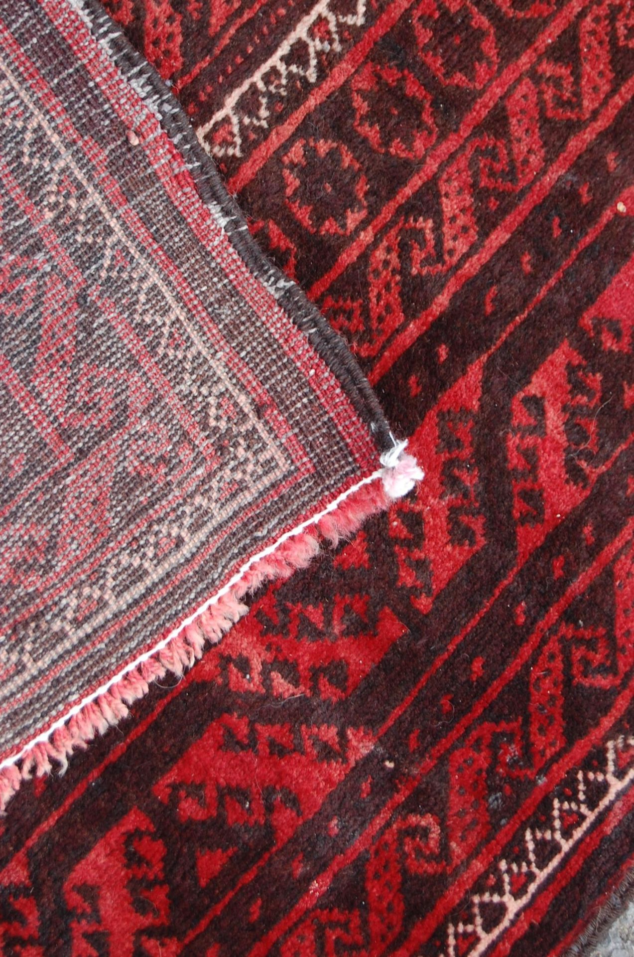 A pair of Islamic / Persian carpet rugs comprising of a red and black carpet having three - Image 9 of 9