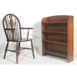 A Victorian 19th century beech and elm wood Wheel back Windsor armchair. The chair being raised on