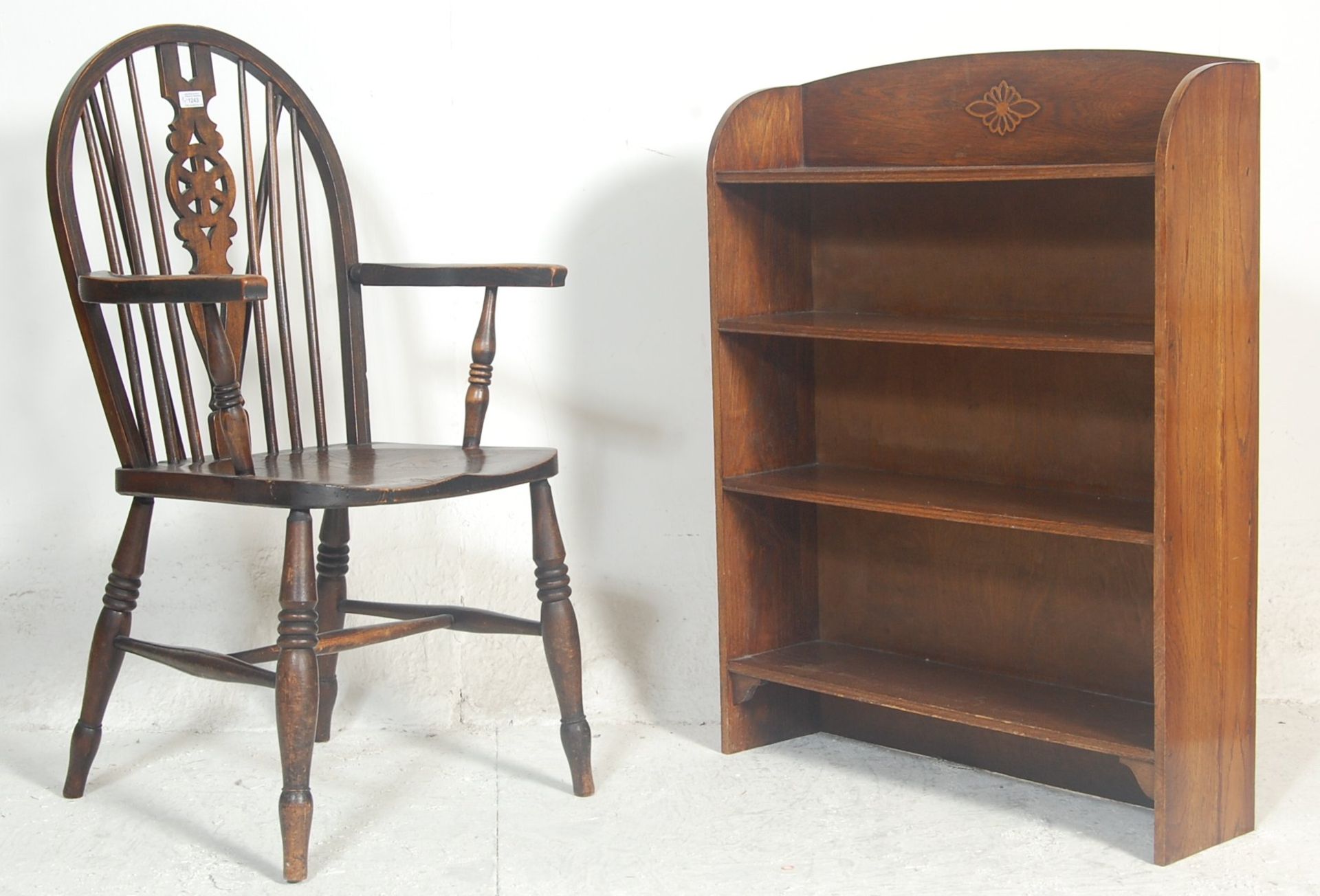 A Victorian 19th century beech and elm wood Wheel back Windsor armchair. The chair being raised on