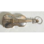 A vintage 20th Century silver plated vesta in the form of a violin having a match strike to the