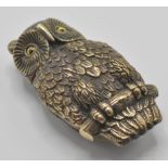 An unusual novelty brass vesta case in the form of an owl perching on a branch with yellow glass