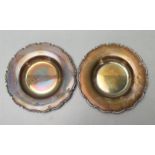 A pair of silver hallmarked small pin dishes of round form having scrolled shaped and raised borders