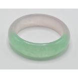 A 20th century ladies oriental Chinese green jade colour bangle, having half moon shape. Measures